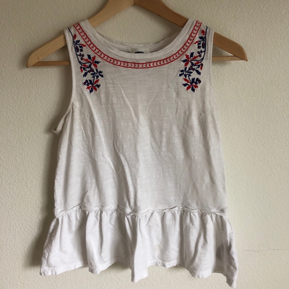 White peplum tank with blue and red detail at neck